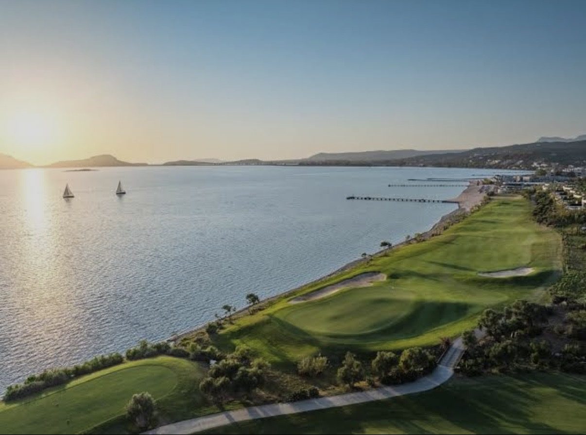 A seaside fairway running along the bay at Costa Navarino at sunset